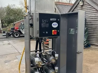 Reconditioned Delta booster pressure washer with cabinet open showing internal pump assemblies before installation at a factory in Measham.